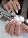Delicate French manicure on a cotton background. French design.