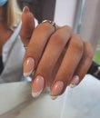 Delicate French manicure. French design with silver stripe.