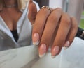 Delicate French manicure. French design with silver stripe.