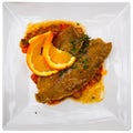 Fried common sole on vegetable ratatouille with fresh orange Royalty Free Stock Photo
