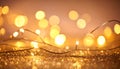 Close up of delicate golden string lights with a soft, blurred bokeh background and sparkling glitter texture Royalty Free Stock Photo