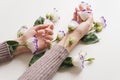 Delicate hands and spring flowers of eustoma are on the white table. the concept of skin care. Natural cosmetics for hand skin Royalty Free Stock Photo