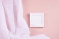 Delicate home decor with blank square photo frame hanging on pastel pink wall, flow of silk curtain . Mock up for portfolio.