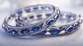 a delicate Indian bangles set adorned with two marquise-cut blue sapphires, elegantly set in 14k white gold, capturing Royalty Free Stock Photo