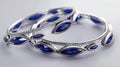 a delicate Indian bangles set adorned with two marquise-cut blue sapphires, elegantly set in 14k white gold, capturing Royalty Free Stock Photo
