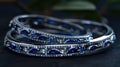 a delicate Indian bangles set adorned with two marquise-cut blue sapphires, elegantly set in 14k white gold, capturing Royalty Free Stock Photo