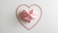 Delicate intricate continuous line heart shape with pink crumpled paper heart shape inside on white background