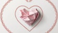 Delicate intricate continuous line heart shape with pink crumpled paper heart shape inside on white background
