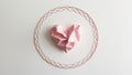 Delicate intricate continuous line heart shape with pink crumpled paper heart shape inside on white background