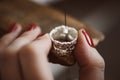 Delicate jewelry work. Close up of a female jeweler`s hand working on a ring resizing at her workbench. Royalty Free Stock Photo