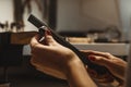 Delicate jewelry work. Close up of a female jeweler`s hands working and shaping an unfinished ring with a tool at