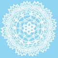 Delicate knitted lace round doily isolated on blue background