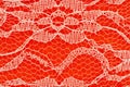 Delicate lace textured material on orange felt background Royalty Free Stock Photo