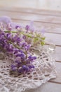 Delicate lilac lupins with flowers showered on a vintage table Royalty Free Stock Photo