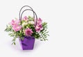 Delicate orchids in a gift box or basket on a light background. Space for text. Bouquet of orchids, roses and chrysanthemums. Royalty Free Stock Photo