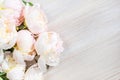 Delicate pale peonies on a white wooden table. Copy Space