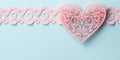 Delicate pink lace heart with an intricate pattern, beautiful curls on delicate blue background. Romantic Valentine