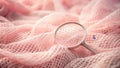 A delicate pink net textile with a magnifying glass resting on it. Generative AI Royalty Free Stock Photo