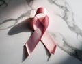 A delicate pink ribbon rests on Royalty Free Stock Photo