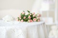 Delicate pink roses and pearl beads on the table