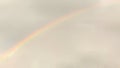 Faint Rainbow in a Cloudy Sky Royalty Free Stock Photo