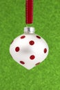 Delicate Red and White Glittery Christmas Ornament Hanging on a Royalty Free Stock Photo