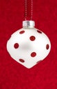 Delicate Red and White Glittery Christmas Ornament Hanging on a