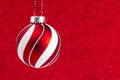 Delicate Red and White Glittery Christmas Ornament Hanging on a Royalty Free Stock Photo