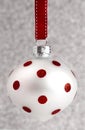 Delicate Red and White Glittery Christmas Ornament Hanging on a