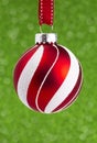 Delicate Red and White Glittery Christmas Ornament Hanging on a