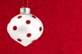 Delicate Red and White Glittery Christmas Ornament Hanging on a