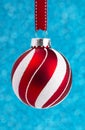 Delicate Red and White Glittery Christmas Ornament Hanging on a Royalty Free Stock Photo