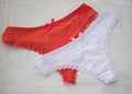 Red and white lingerie. Red and white lace thong on white background. Royalty Free Stock Photo