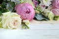 Delicate romantic bouquet for a gift. Huge pink peonies and white roses on a white background. Royalty Free Stock Photo