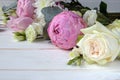 Delicate romantic bouquet for a gift. Huge pink peonies and white roses on a white background. Royalty Free Stock Photo