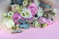 Delicate romantic bouquet for a gift. Huge pink peonies and white roses on a pink background. Royalty Free Stock Photo