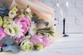 Delicate romantic bouquet for a gift. Huge pink peonies and white roses, two champagne glasses on a white background. Royalty Free Stock Photo