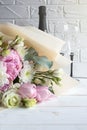 Delicate romantic bouquet for a gift. Huge pink peonies and white roses, two champagne glasses on a white background. Royalty Free Stock Photo