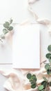 Elegant Wedding Invitation Mockup: Flat Lay with Blank Card, Eucalyptus Greenery, and Soft Pink Fabric Royalty Free Stock Photo