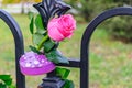 Delicate rose and padlock decorate the road railing Royalty Free Stock Photo
