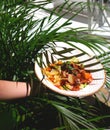 Delicate salad with ripe peach, cherry tomatoes, prosciutto, Parmesan cheese and honey-mustard sauce against the Royalty Free Stock Photo