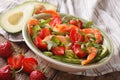 Delicate salad with strawberries, avocado, shrimp and arugula