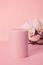 Delicate scented pink candle over pastel pink background with copy space