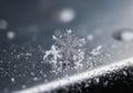 A delicate snowflake rests on a smooth, metallic surface, showcasing its intricate hexagonal Royalty Free Stock Photo