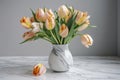 delicate spring tulips in a simple vase on a marble tabletop