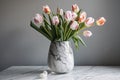 delicate spring tulips in a simple vase on a marble tabletop