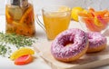 Delicate strawberry doughnuts with sugar sprinkles for a tea break.