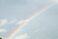 Delicate summer rainbow on the blue sky after the rain Royalty Free Stock Photo
