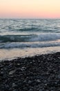 Delicate sunset on the pebble sea.