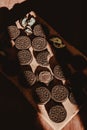Delicate sweet chocolate oreo cookies on a wooden table on a beautiful sunny day